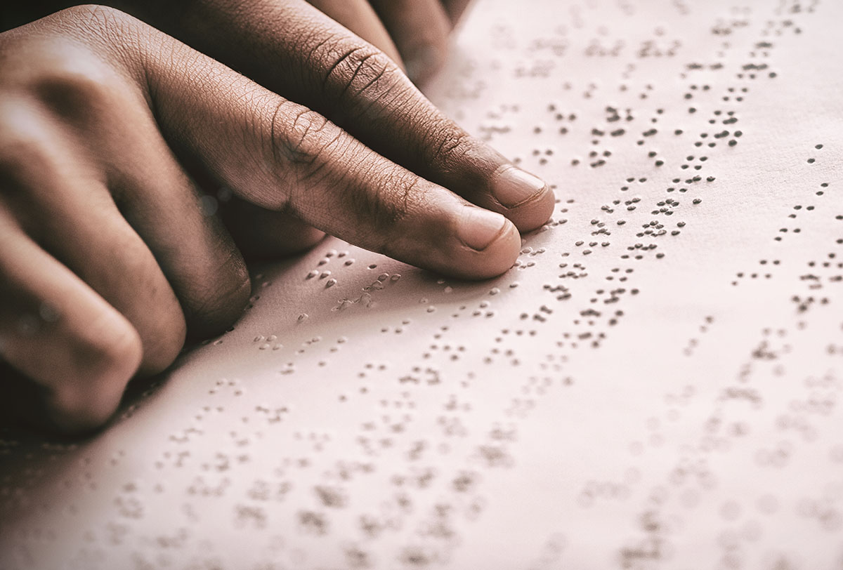 Image of person reading braille