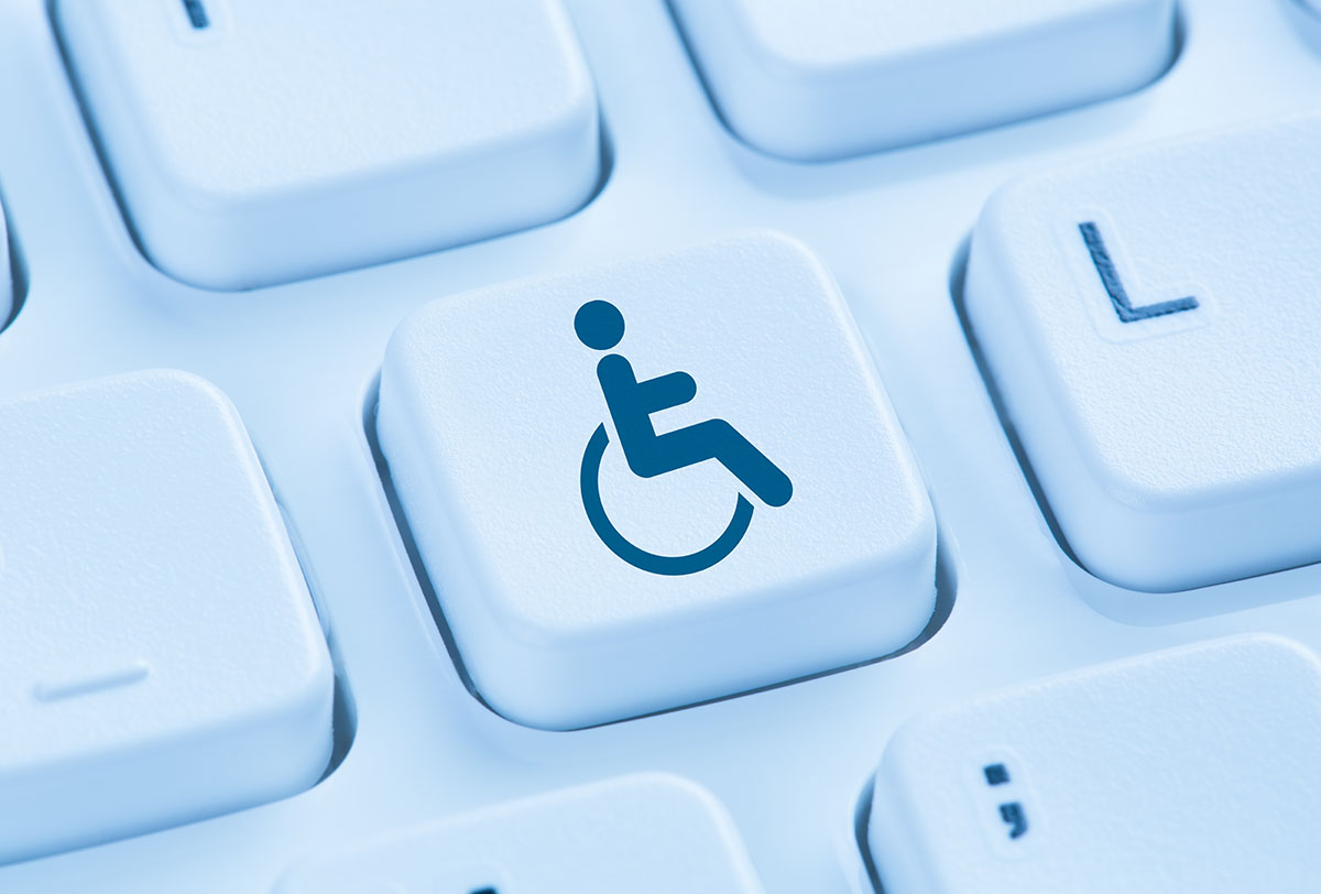Computer keyboard with one key highlighted with a disability symbol