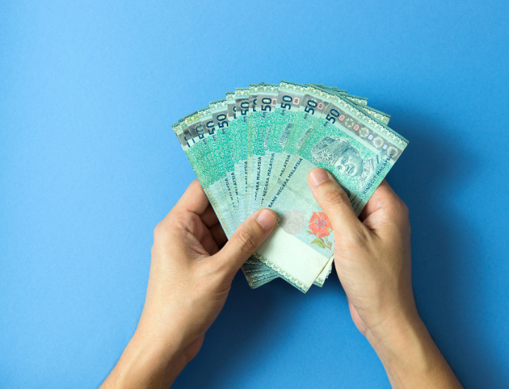 Woman holding dollar notes